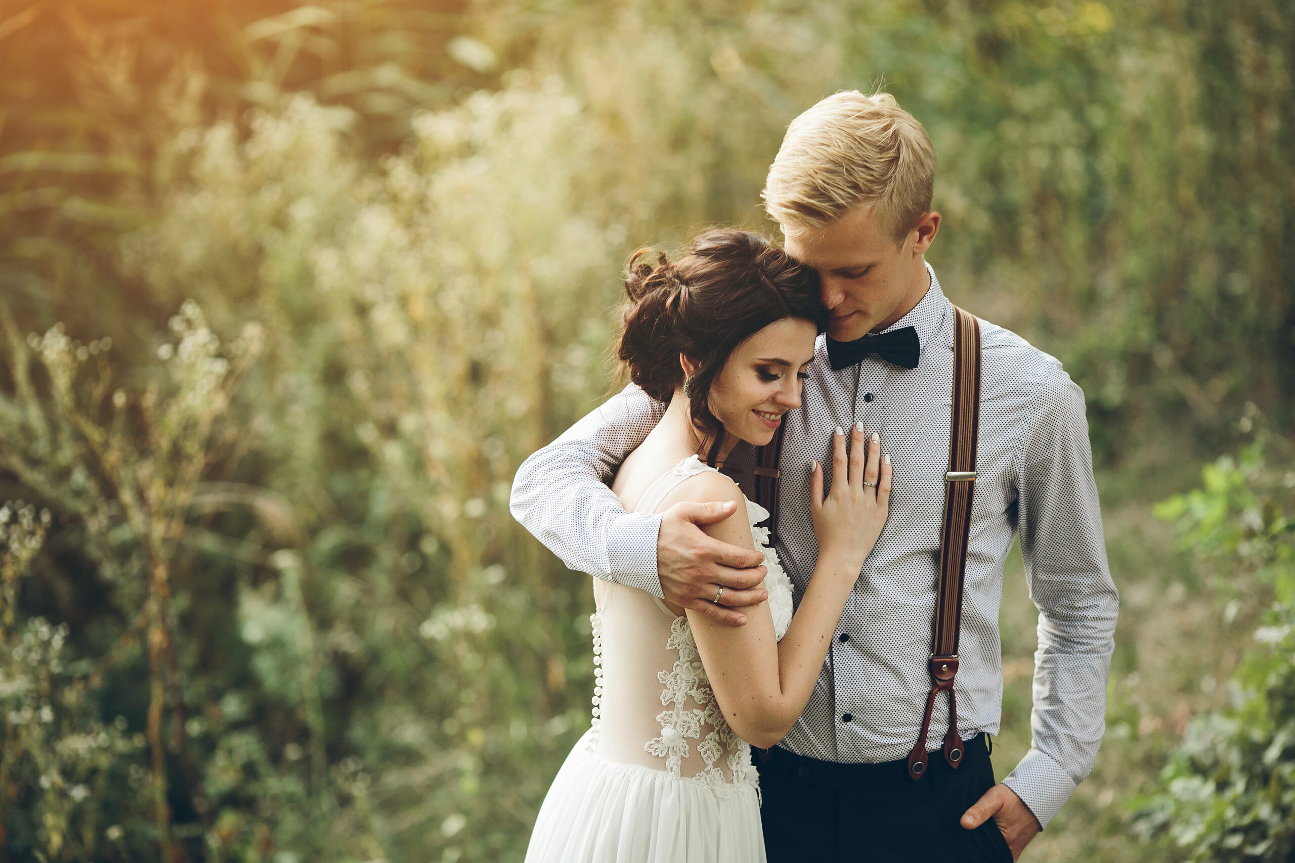 groom gently embracing his bride