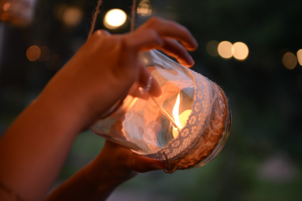 Mason jar candle hanging for wedding decor. Evening light. window
