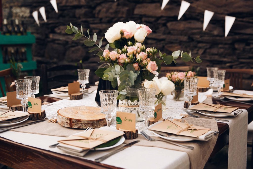 Little dinner table served in rustic style and decorated with pi